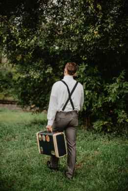 man carrying black and gold briefcase